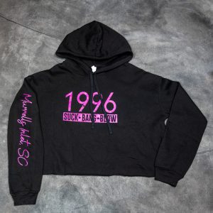 Our Women’s crop 1196 hoodie is super soft and is a lightweight hoodie. This cute hoodie is Bella & Canvas brand fleece hoodie. It’s 52% Cotton and 48% Polyester. It features Suck Bang Blow under a large printed 1996 and measures 5.5”H x 9.5”. A sleeve has a printed Murrells Inlet, SC. These crop hoodies come in four colors. White/blue lettering, Grey/black lettering, Black/hot pink lettering & Army green/white lettering. Available in sizes Sm - 2XL.